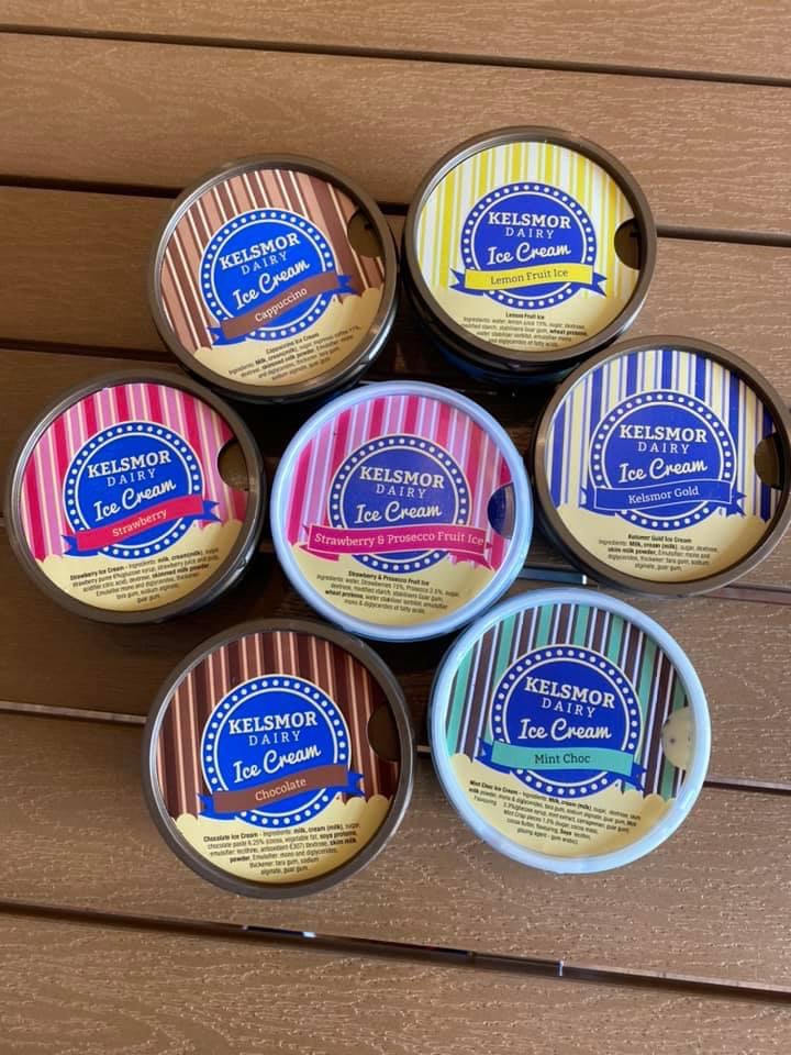 Birdseye photo of 7 tubs of Kelsmor Dairy ice cream all with different flavours